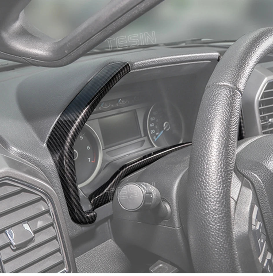 Carbon fiber grain trim cover for a Ford F-150 center console and steering wheel area.