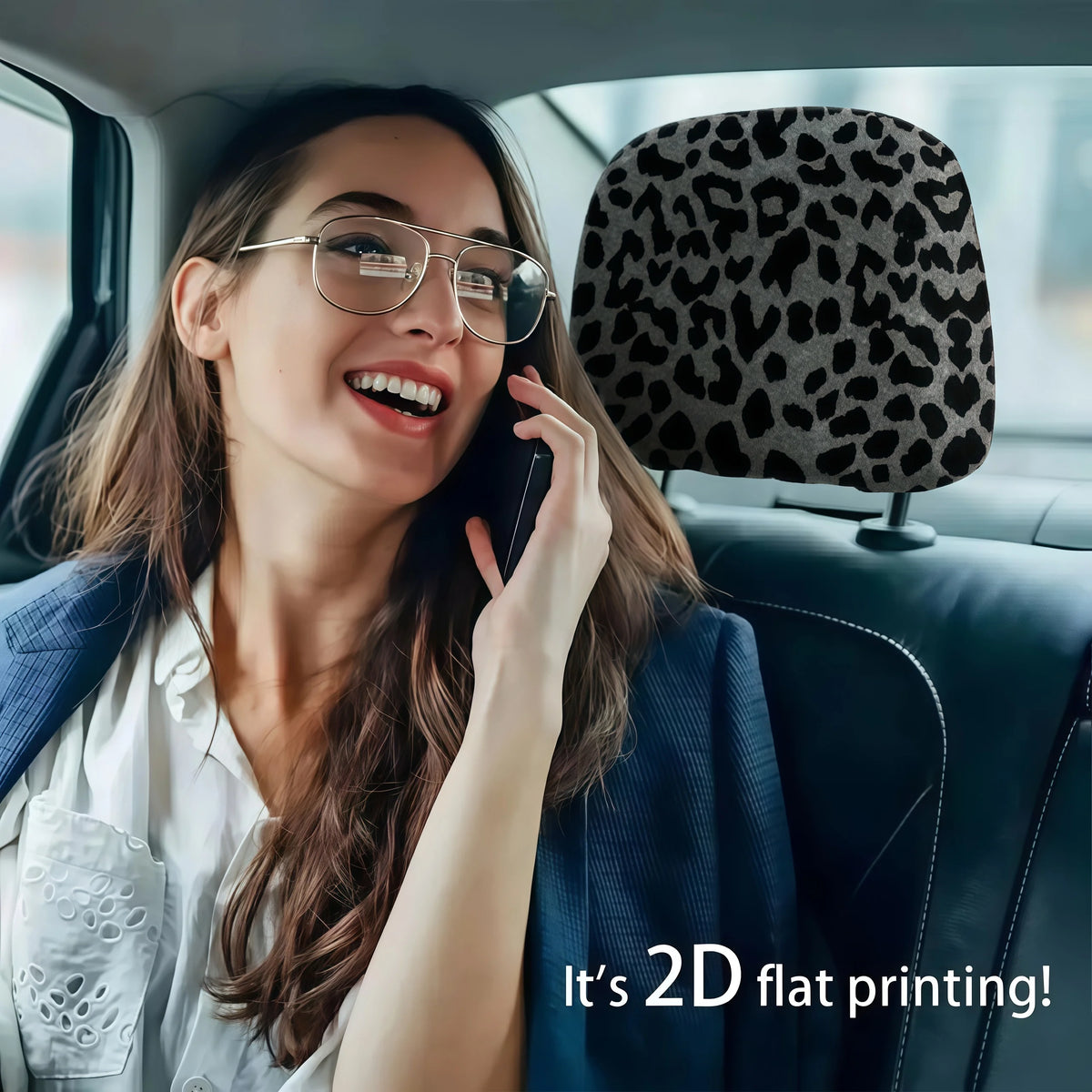 A woman smiling while using a phone in a car, featuring leopard print headrest covers.