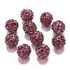 A collection of round, deep pink crystal clay beads for DIY jewelry and craft projects.