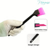 A hand is using a black tool with a pink rubber strip for car window film installation.