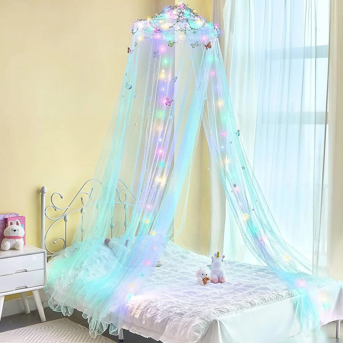 A sheer light blue dome mosquito net with LED lights draped over a bed for mosquito protection.