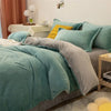 A teal flannel duvet cover is displayed on a bed with light green and yellow accent pillows.