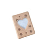 A square photo album cover with a gold frame and a heart-shaped cutout on a light blue background.