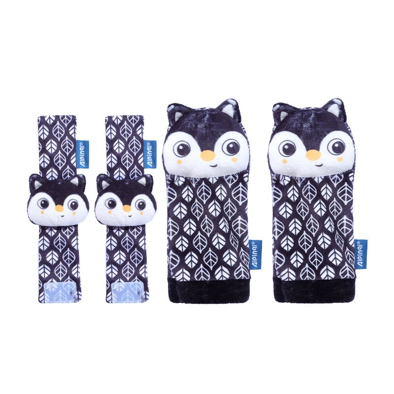 A set of four black and white baby wrist and foot rattles featuring owl designs.
