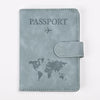 A grey leather passport holder featuring a world map and an airplane icon.