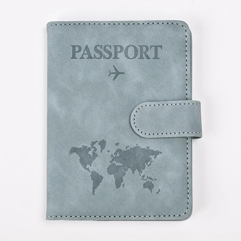 A grey leather passport holder featuring a world map and an airplane icon.