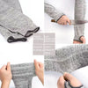 Close-up view of gray knit cut-resistant arm sleeves being worn on an arm.