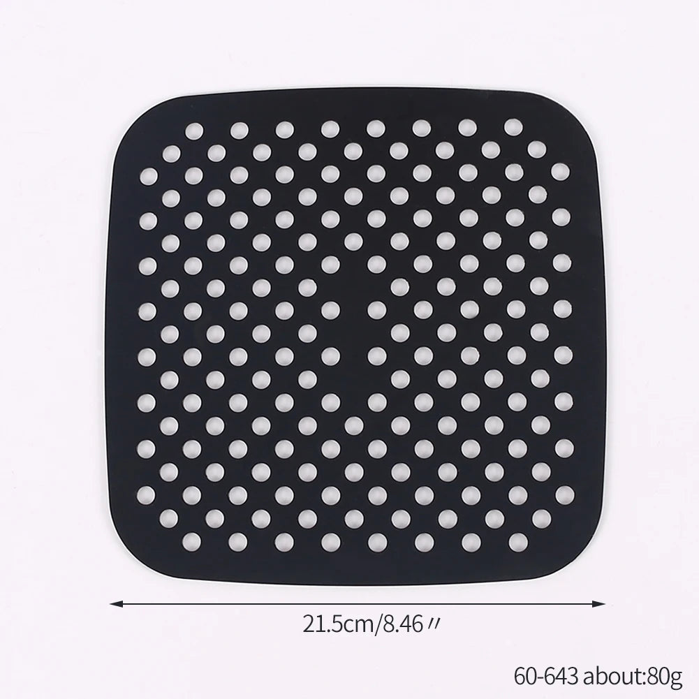 Black reusable silicone air fryer liner with a grid of circular holes.