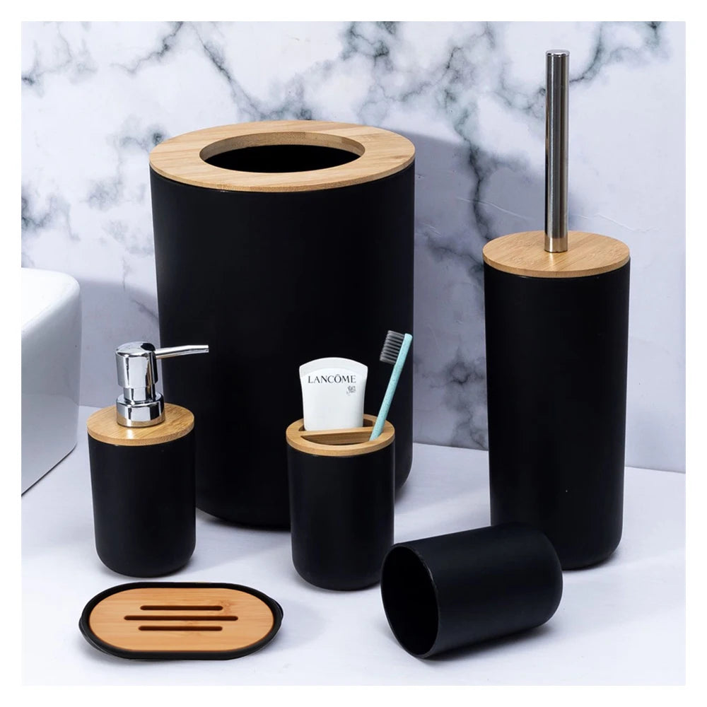 A set of black and bamboo bathroom organizers including a soap dispenser and a small holder.