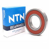 A blue box labeled NTN Bearings next to a metallic deep groove ball bearing.