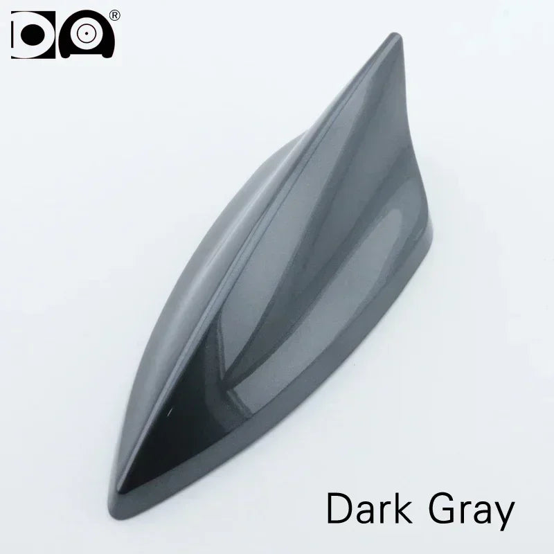 A sleek, dark gray shark fin car antenna with a smooth, aerodynamic shape.