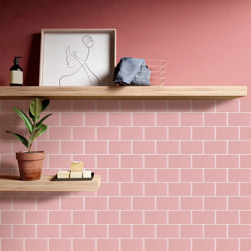 A display of 3D waterproof peel-and-stick kitchen wall tiles in a pink color on wooden shelves.