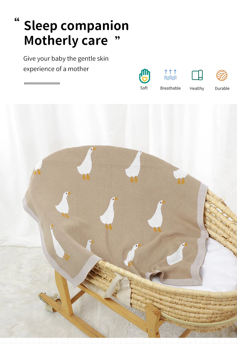 A beige cotton baby swaddle blanket with a white duck cartoon print is displayed in a wicker basket.