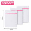 A set of three white mesh laundry bags with pink trim are displayed, showing their size and packaging.