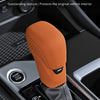 Orange liquid silicone rubber gearshift cover with carbon fiber texture and integrated design shown in a vehicle interior con