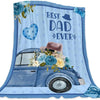 A light blue fleece throw blanket featuring a watercolor design of a vintage car surrounded by blue and yellow flowers with '