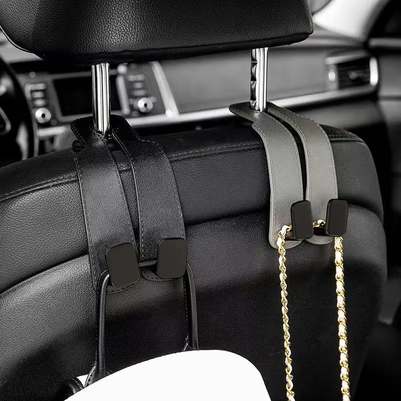 Black car headrest hooks with gold chains for hanging bags and organizers