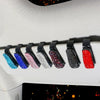 A row of crystal rhinestone clips for car sun visor sunglasses, featuring various colors like blue, pink, silver, purple, and