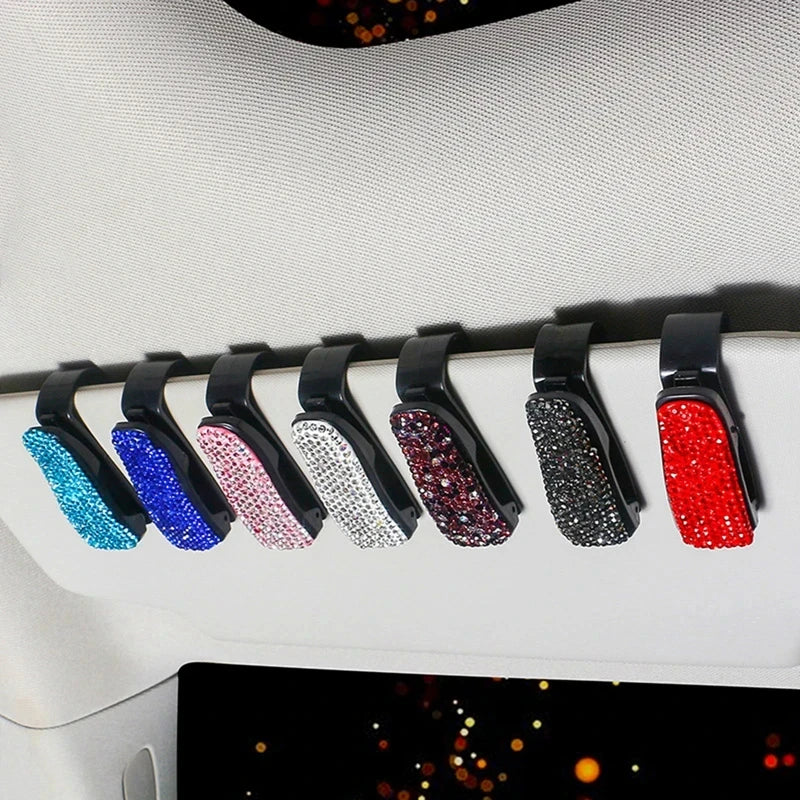 A row of crystal rhinestone clips for car sun visor sunglasses, featuring various colors like blue, pink, silver, purple, and