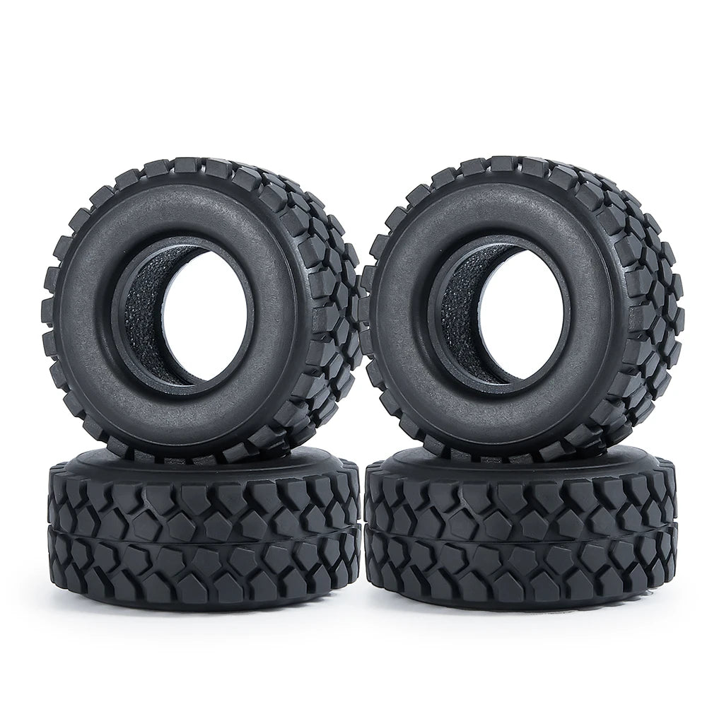 Two black rubber mud terrain tires stacked on top of each other