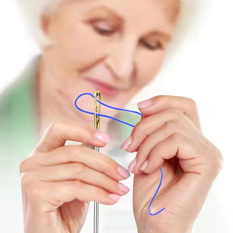 A woman's hands are threading a blue sewing needle into another, demonstrating the use of 12-piece self-threading sewing need
