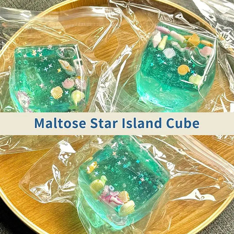 A translucent teal cube shaped like a star island, packaged for stress relief.
