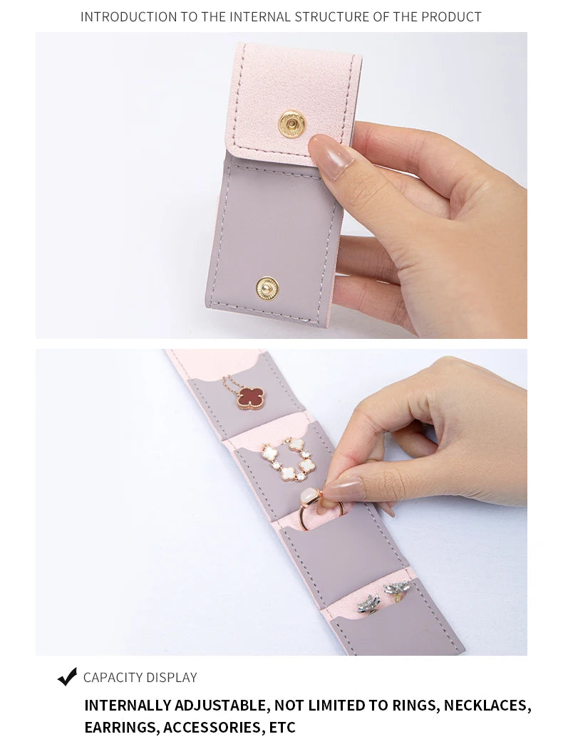 A hand holds a pink PU leather jewelry organizer pouch with four compartments, showing its internal structure.