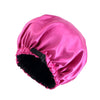 A bright pink satin sleep bonnet with a black trim and velvet lining.