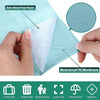 A hand is holding a thin, white material layered between a green paper and a waterproof PE membrane.