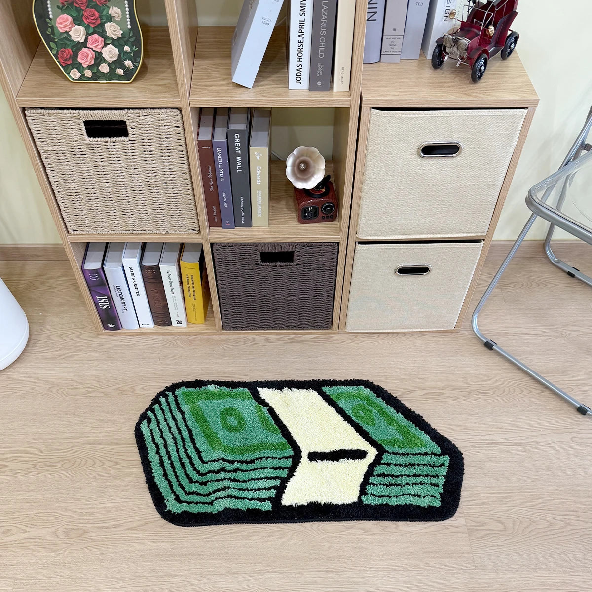 A green and yellow cartoon dollar bill tufted non-slip mat displayed on a wooden shelf with various storage baskets.