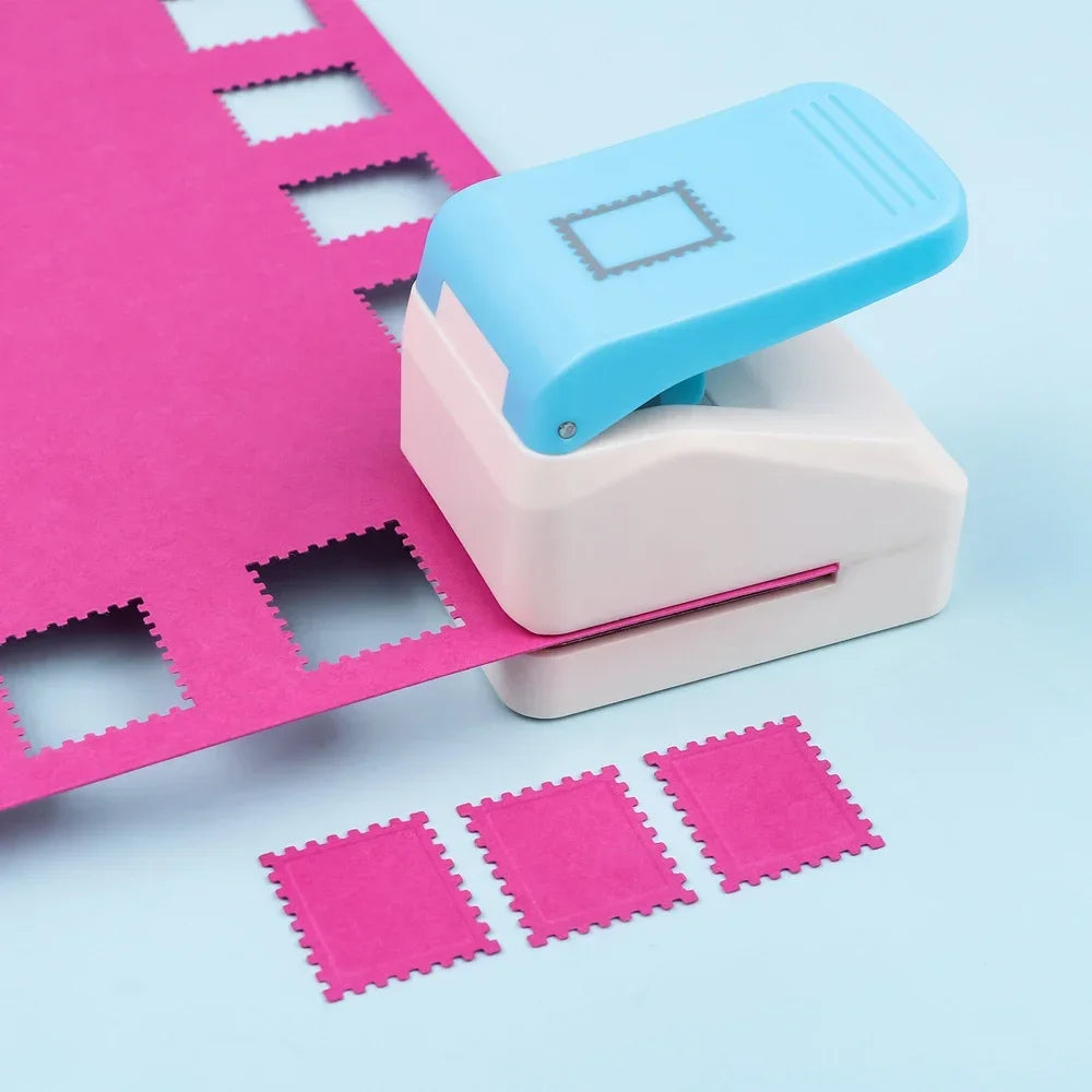 A light blue postage stamp embossing punch is shown next to a pink sheet of paper and several pink stamps.