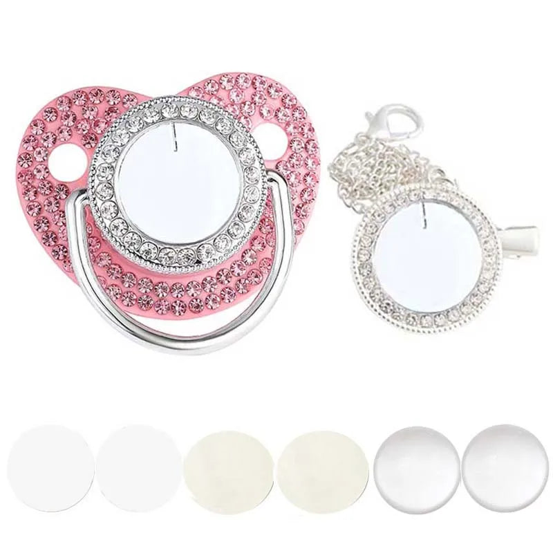 Pink rhinestone pacifier with clip for babies and a set of white silicone pacifiers
