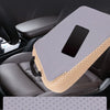A gray breathable 3D mesh car seat cushion with memory foam support placed on a dark car seat.