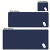 A dark blue oversized non-slip desk mat for gaming and office with a white mousepad visible.