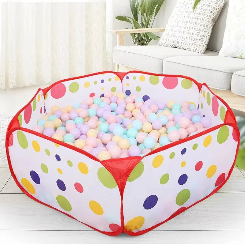 A pink foldable kids play tent with a ball pool pit filled with colorful plastic balls.