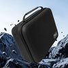 Black hard-shell travel case for hair clippers and accessories shown against a rocky background.