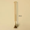 A beige hands-free toilet lid lifter tool shown vertically against a light background.