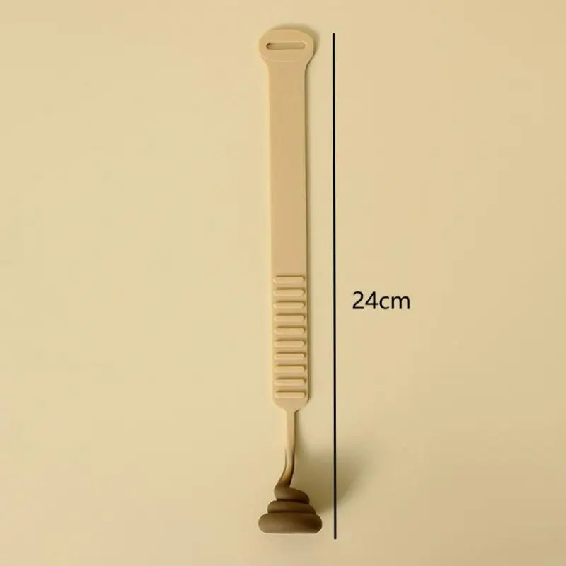 A beige hands-free toilet lid lifter tool shown vertically against a light background.