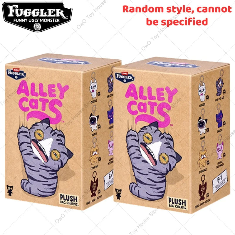 A box of Fuggler Alley Cats plush bag charms featuring a purple striped cat character.