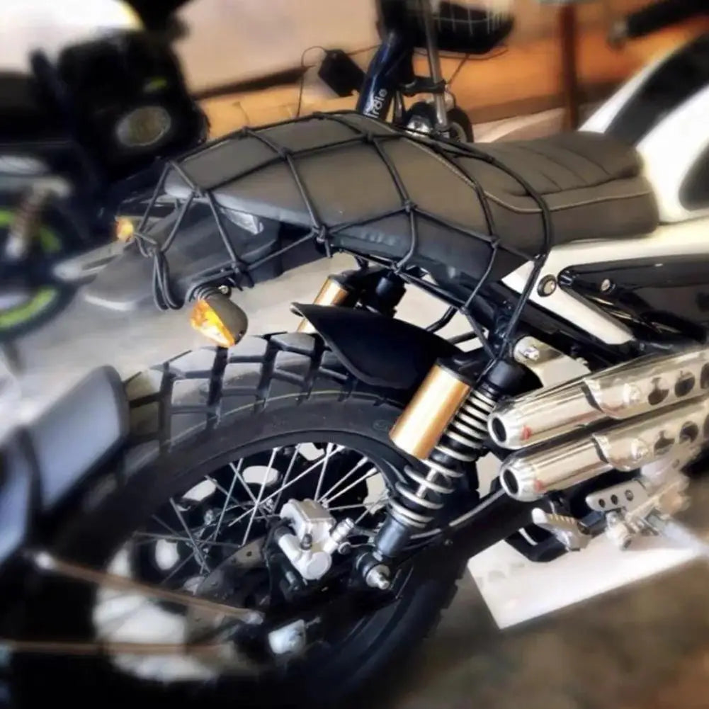 A black motorcycle features a bungee cargo net with scratch-free hooks mounted on the frame.