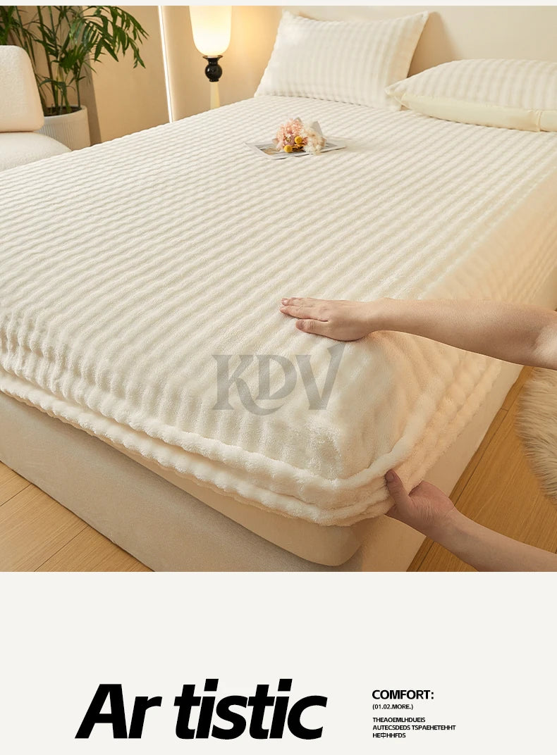 A close-up of a white, textured fitted sheet with faux fur trim on a bed, showing the fabric texture and softness.