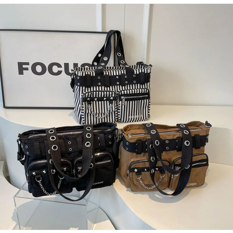 A display of black and white nylon shoulder bags with chain accents, featuring striped and solid fabric designs.