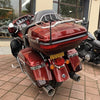 A close-up view of a red motorcycle with a Universal Car Radio Antenna mounted on the back.