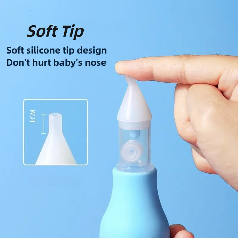 A hand is holding a blue baby nasal aspirator with a soft silicone tip, demonstrating its gentle design.