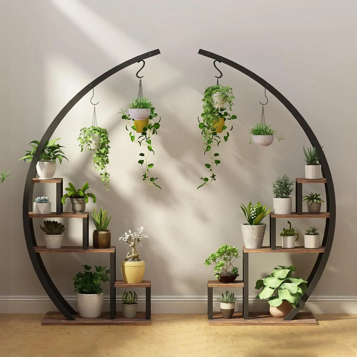 A black metal half moon stand features multiple tiers for potted plants and hanging hooks.