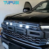 Close-up of a black Ford Ranger Raptor grille with white LED light kit installed.