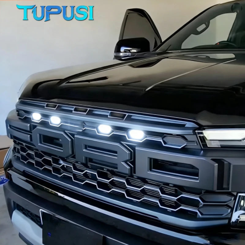 Close-up of a black Ford Ranger Raptor grille with white LED light kit installed.