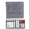 A gray leather card holder wallet featuring a silhouette of a car and text for registration and insurance documents.