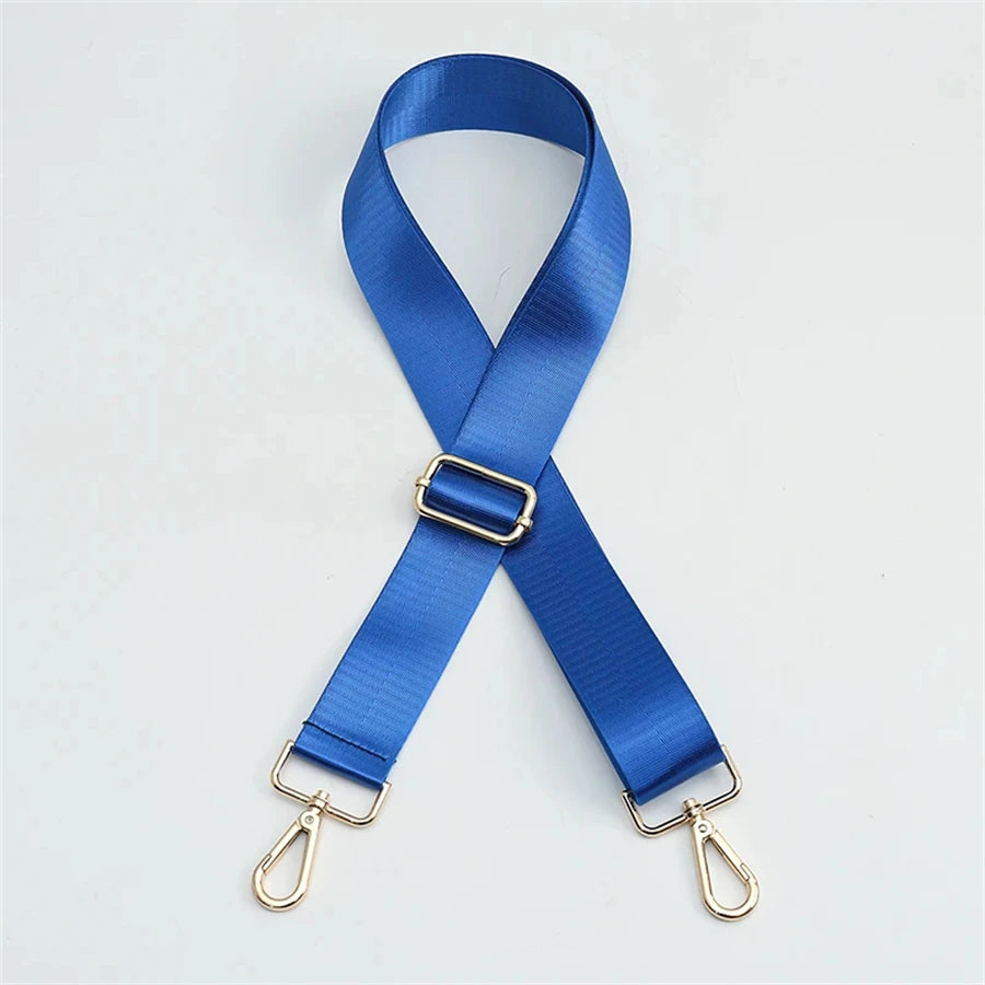 Blue nylon bag strap with a gold buckle shown in an 'X' shape.