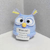 Handmade crochet owl doll with blue body and yellow accents, featuring a humorous quote about wisdom.